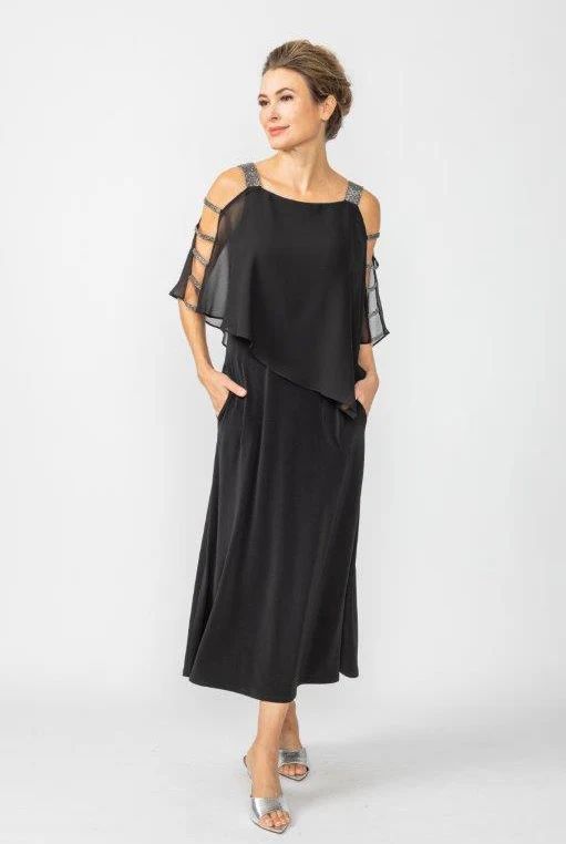 A woman is wearing a black dress and silver shoes