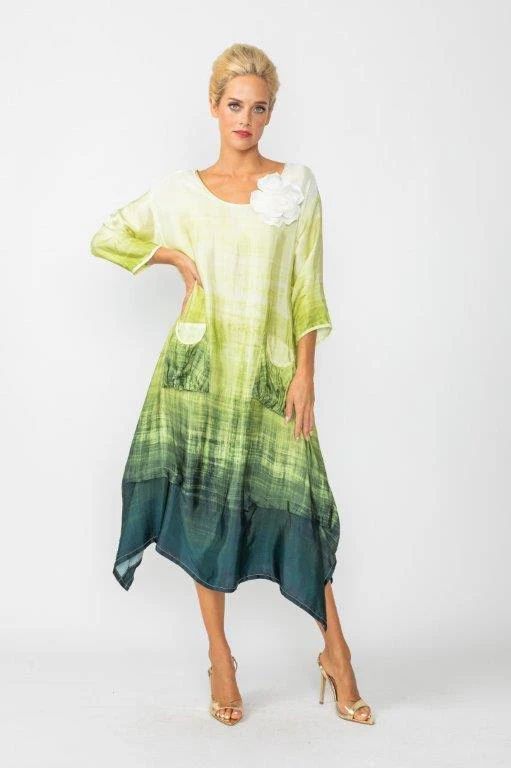 A woman is wearing a green and white dress and heels