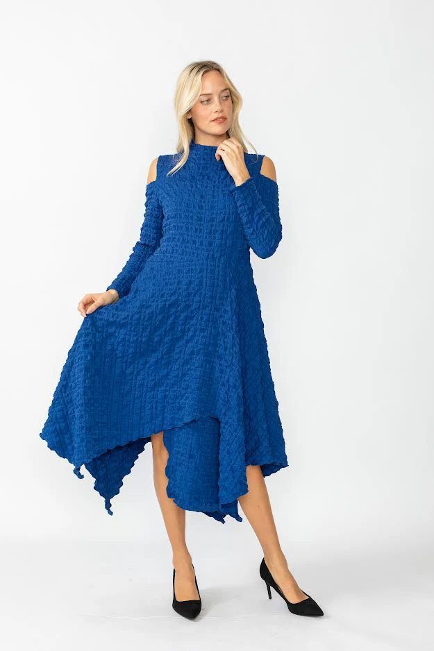 A woman is wearing a blue dress with a high low skirt and black heels