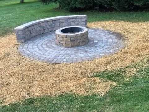 Sandy surface with curved, parallel shadows.