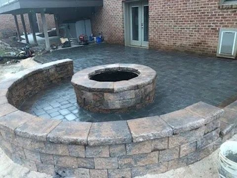 Brick patio with fire pit and curved seating wall.