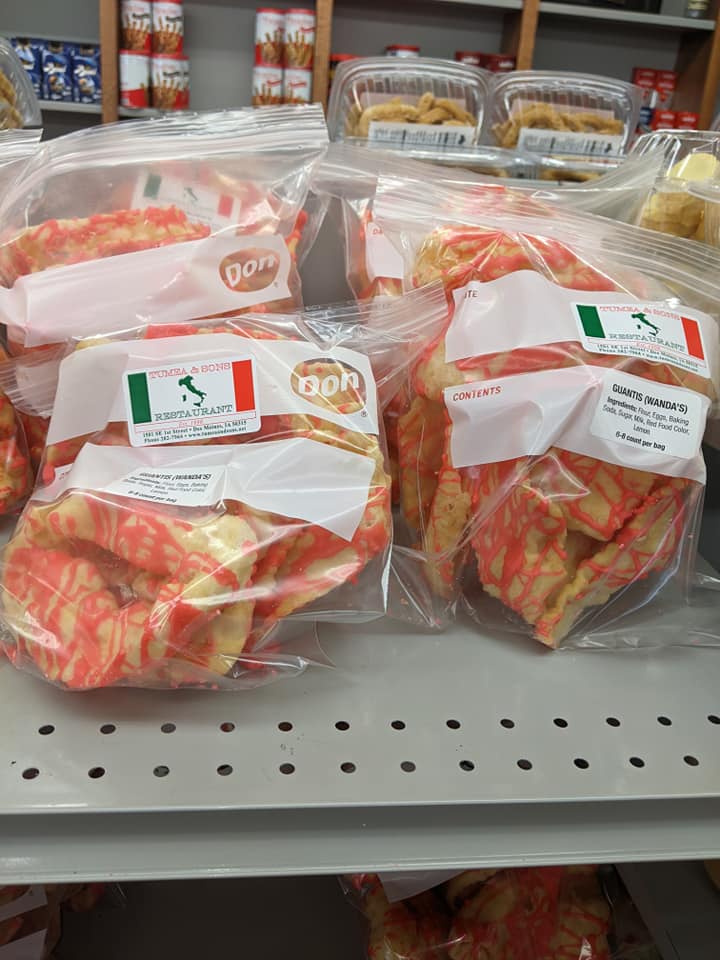 A bunch of bags of food are sitting on a shelf in a store.