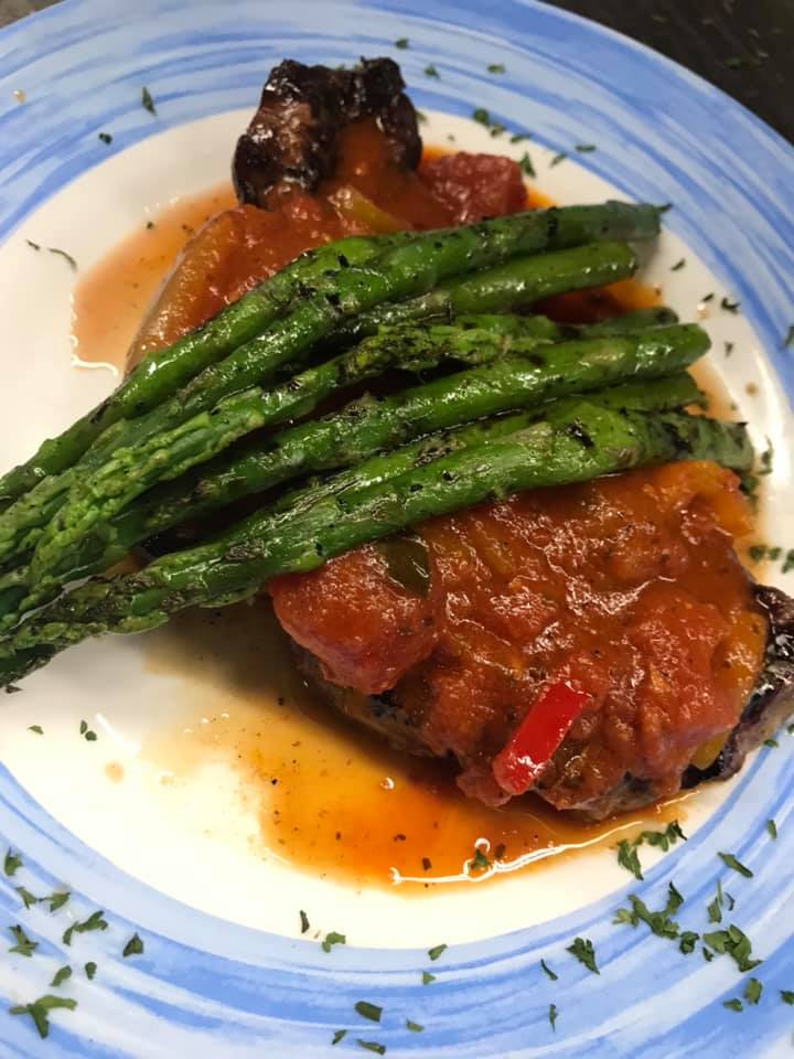 A plate of food with green beans and sauce on it