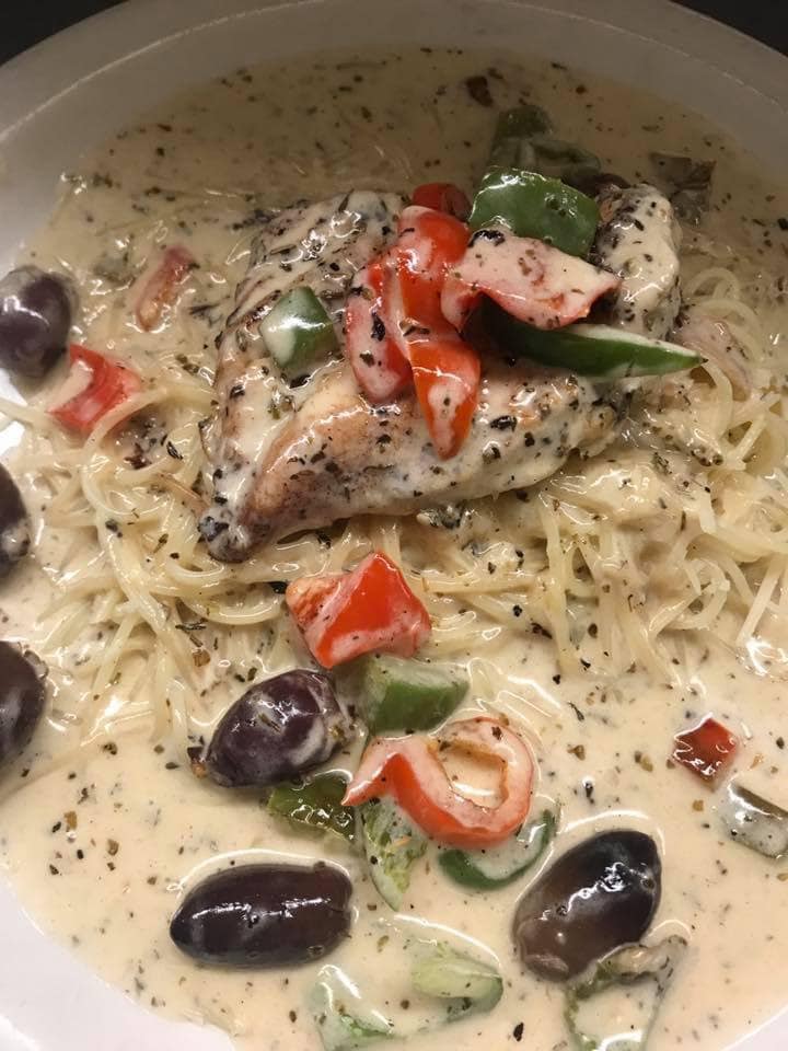 A close up of a plate of food with noodles and vegetables
