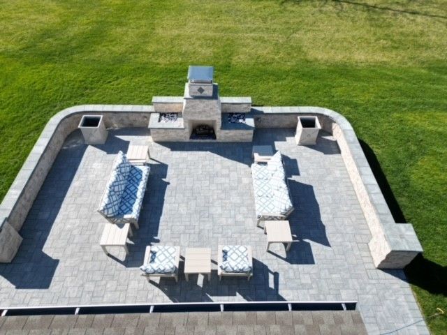 An aerial view of a patio with furniture and a fireplace
