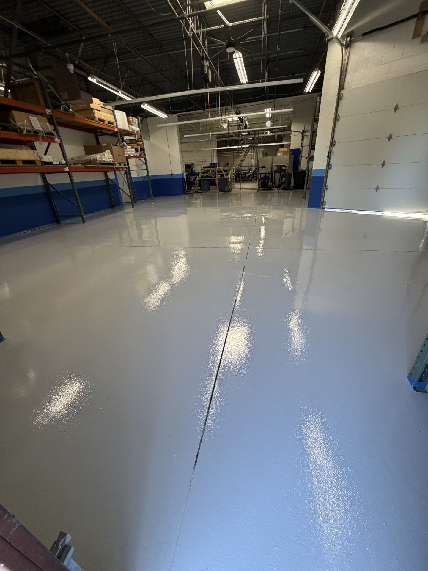 White epoxy coated garage floor with a long black line down the center.