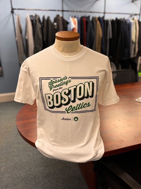 A white boston celtics t-shirt is on a table