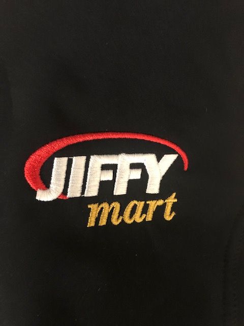 A black shirt with a jiffy mart logo on it