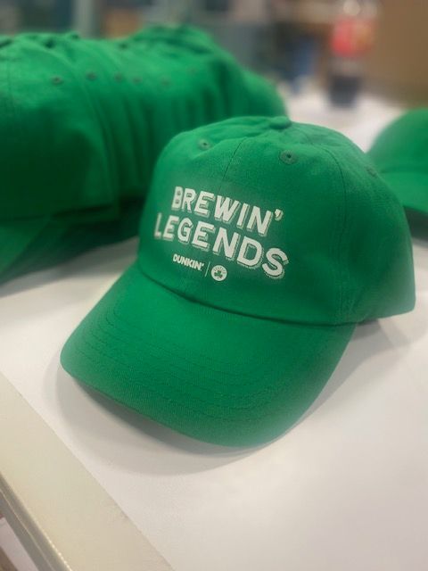 A green baseball cap that says brewin legends on it