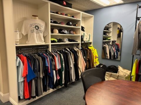 A room filled with lots of clothes and hats.