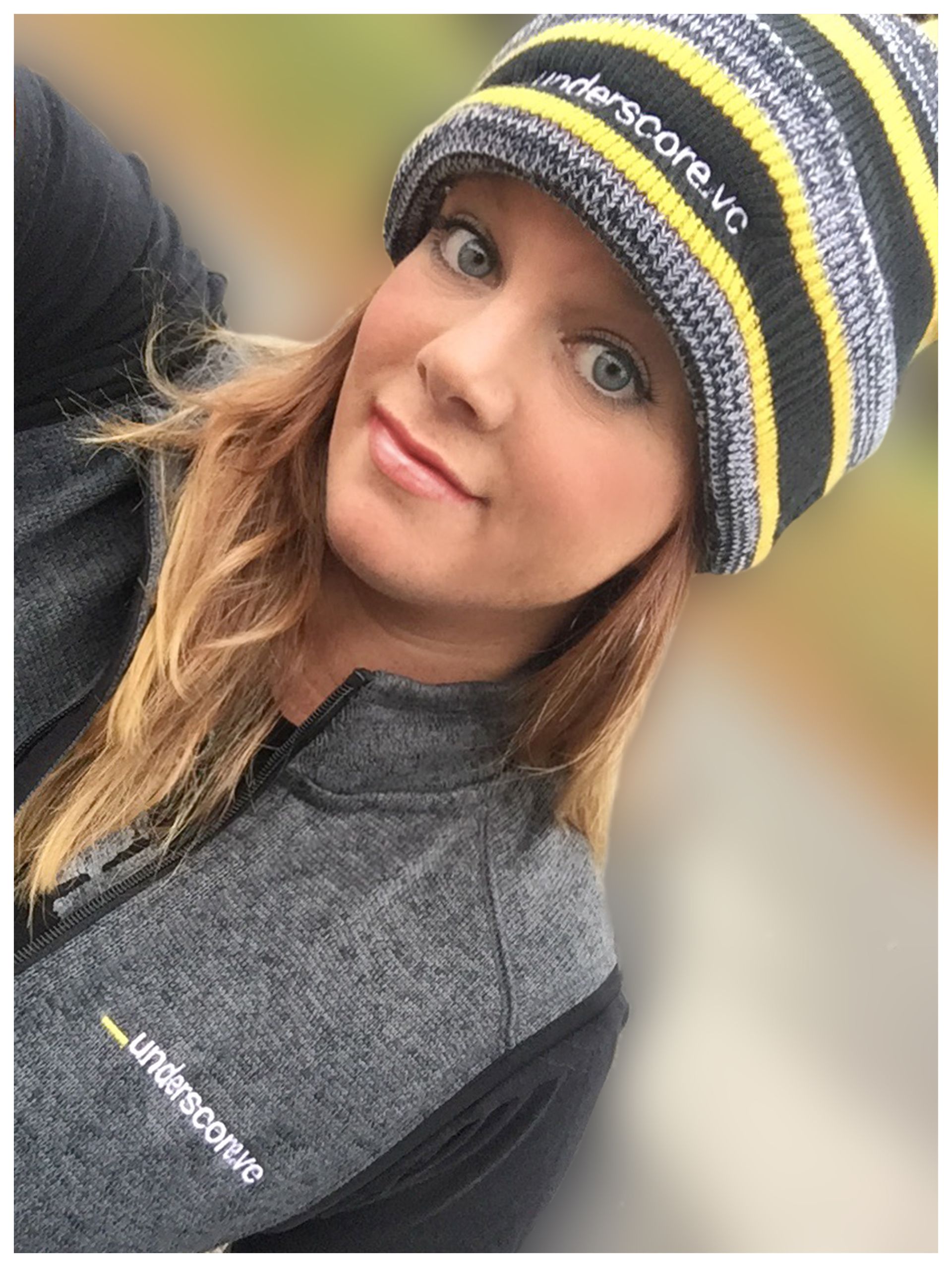 A woman wearing a black and yellow striped beanie