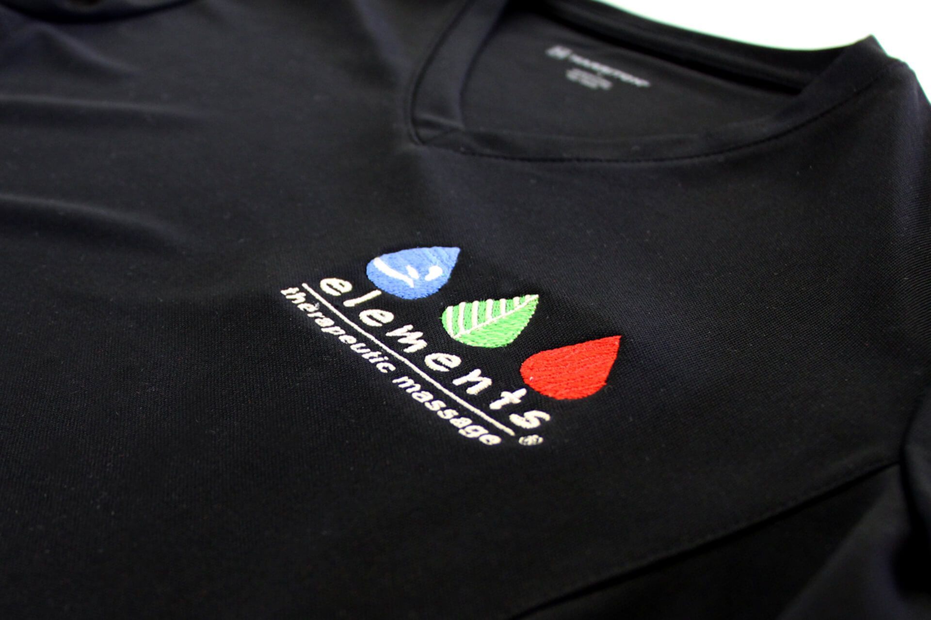 A black shirt with the word elements embroidered on it