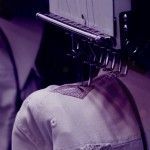 A person is using a sewing machine to make a hat.