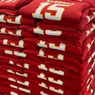 A stack of red shirts with the number 15 on them