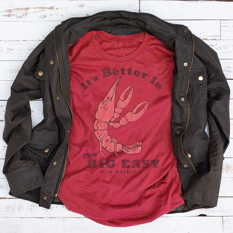 A red shirt that says it 's better in the big easy