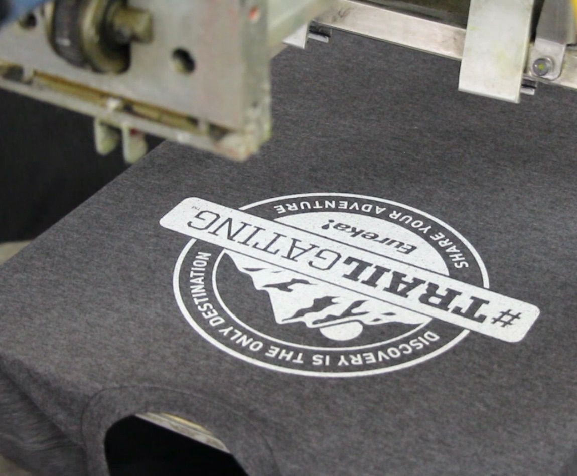 A person is holding a green boston celtics t-shirt