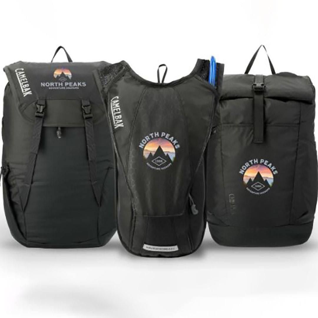 Three black backpacks with the word north peaks on them