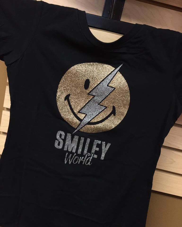 A black shirt with a smiley face and lightning bolt on it