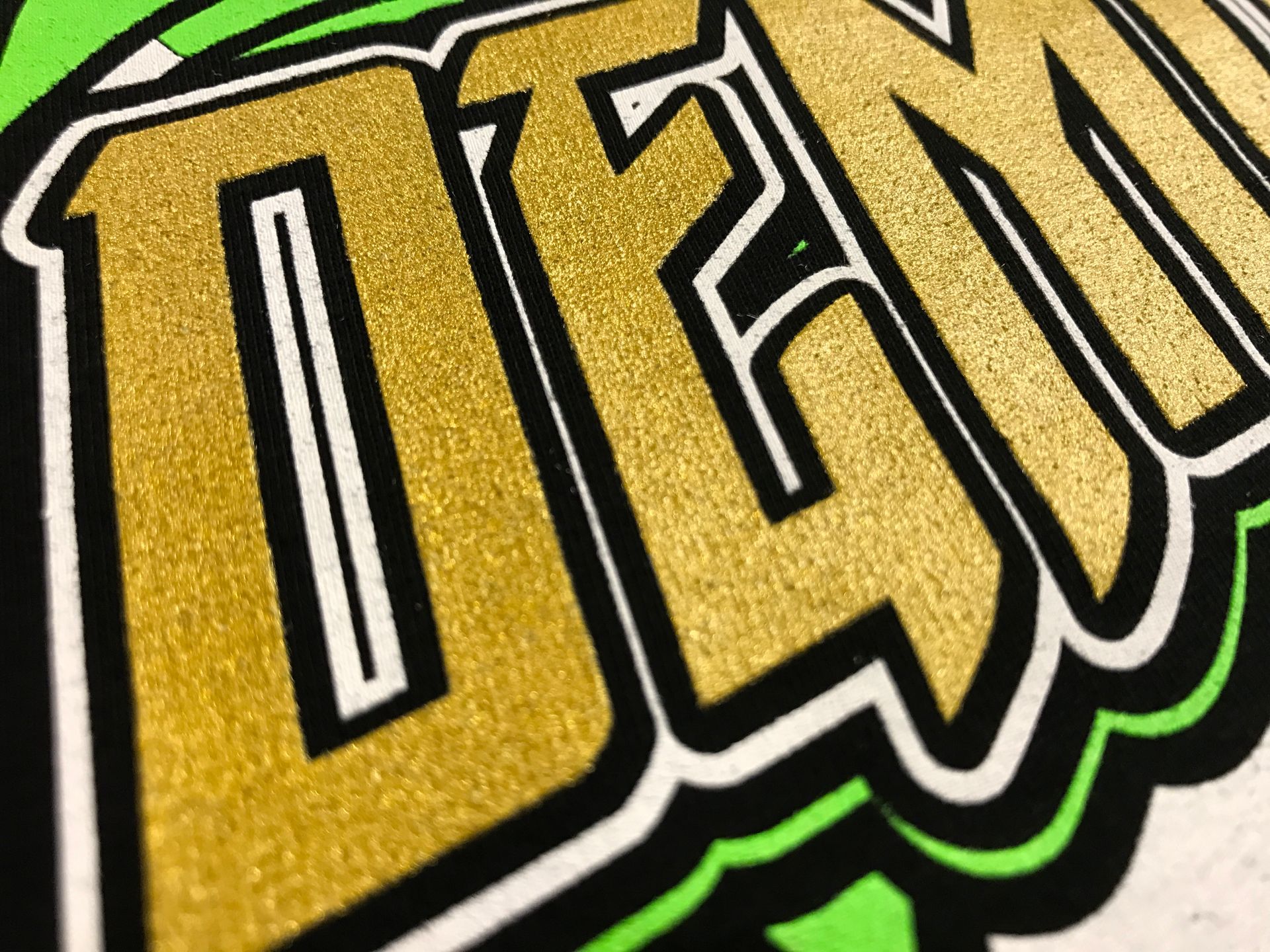 A close up of the word den on a green and white background.