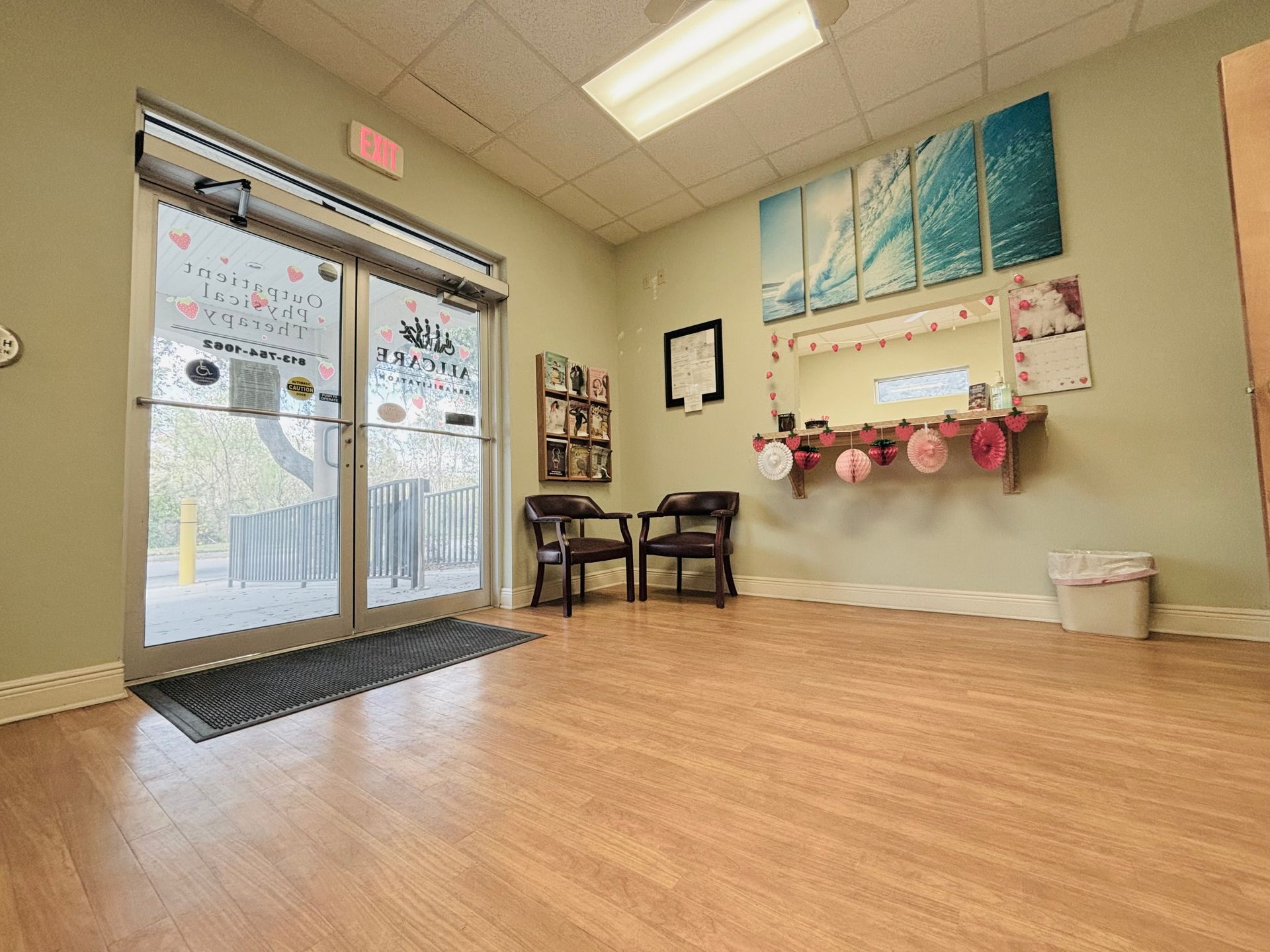 A large room with wooden floors and a sliding glass door.