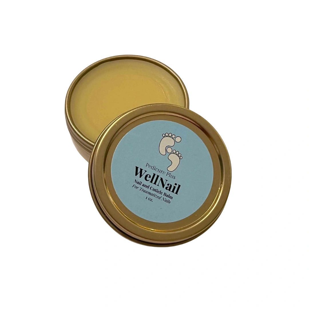 WellNail foot cream tin, open. Gold rim, light blue label with a foot graphic. Yellow balm inside.