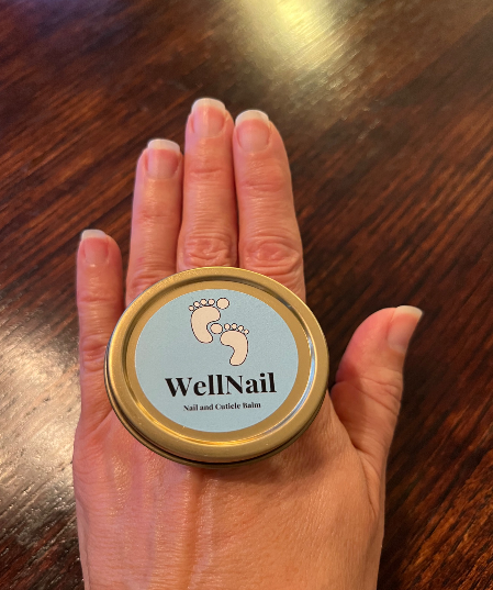 Hand holding a round tin of 