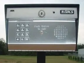 Large roadside emergency call box with keypad and “Push Button To Call” text beside a road
