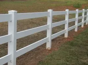 White wooden fence along a grassy field