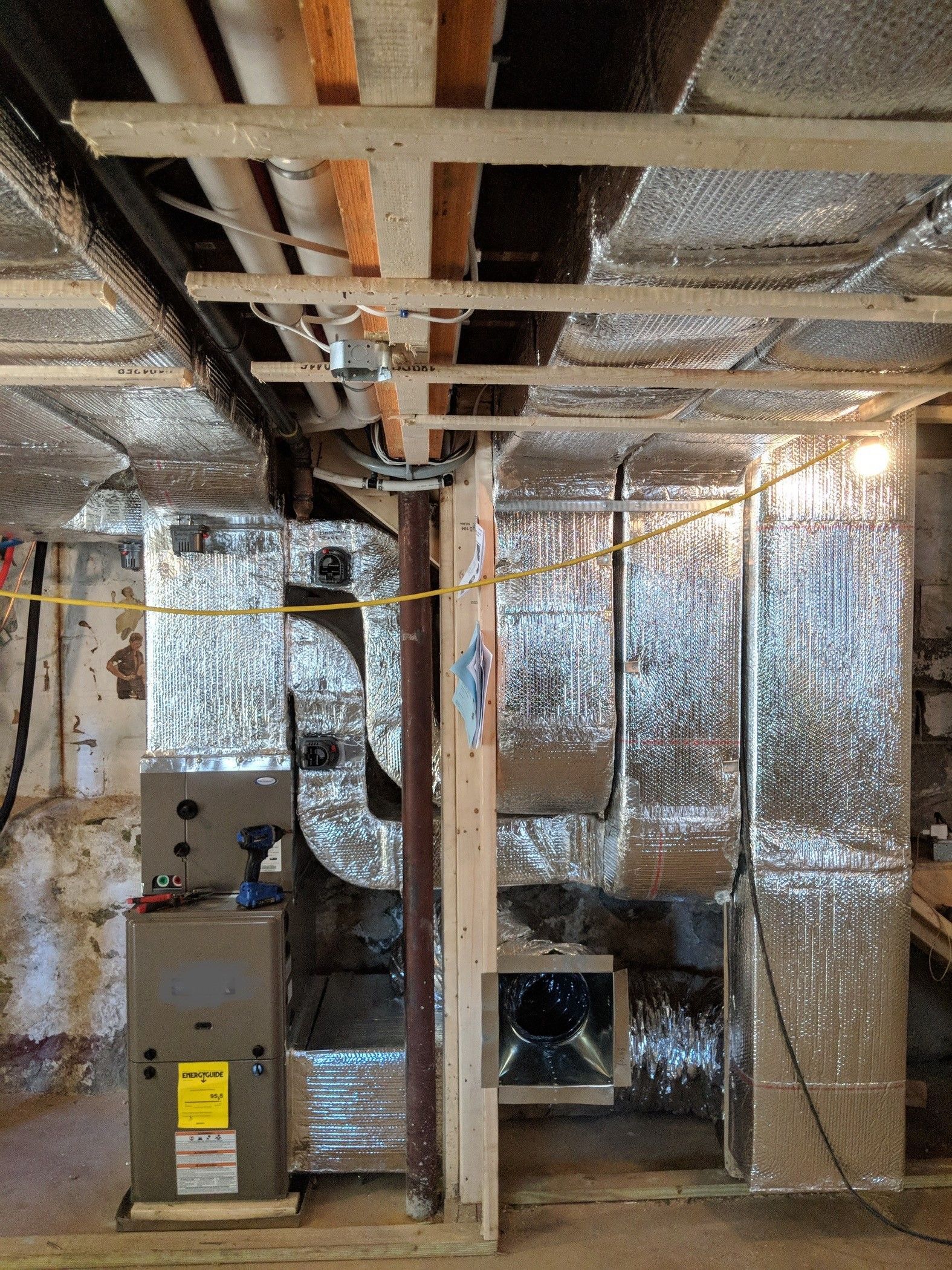 A basement with a furnace and air ducts.