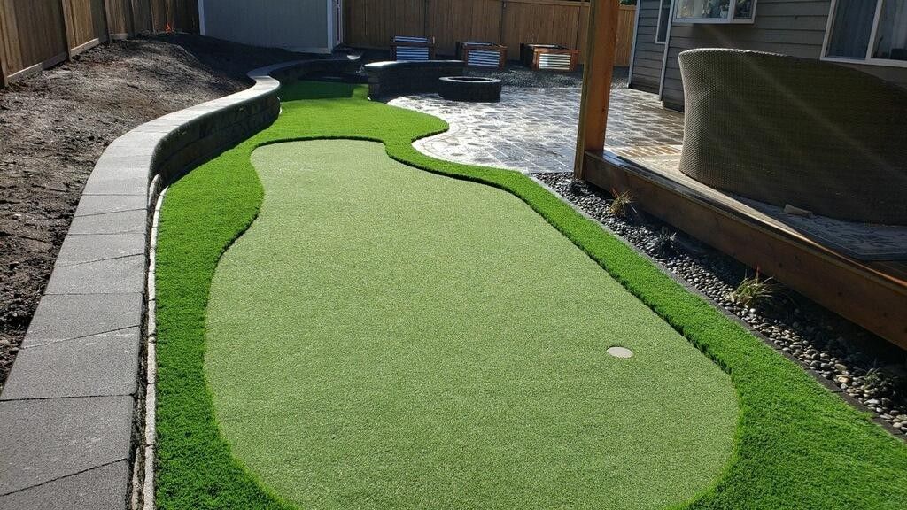 A single-story house with a green lawn and gravel driveway.