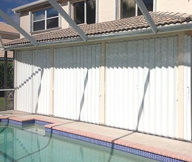 Accordion shutters for storm protection