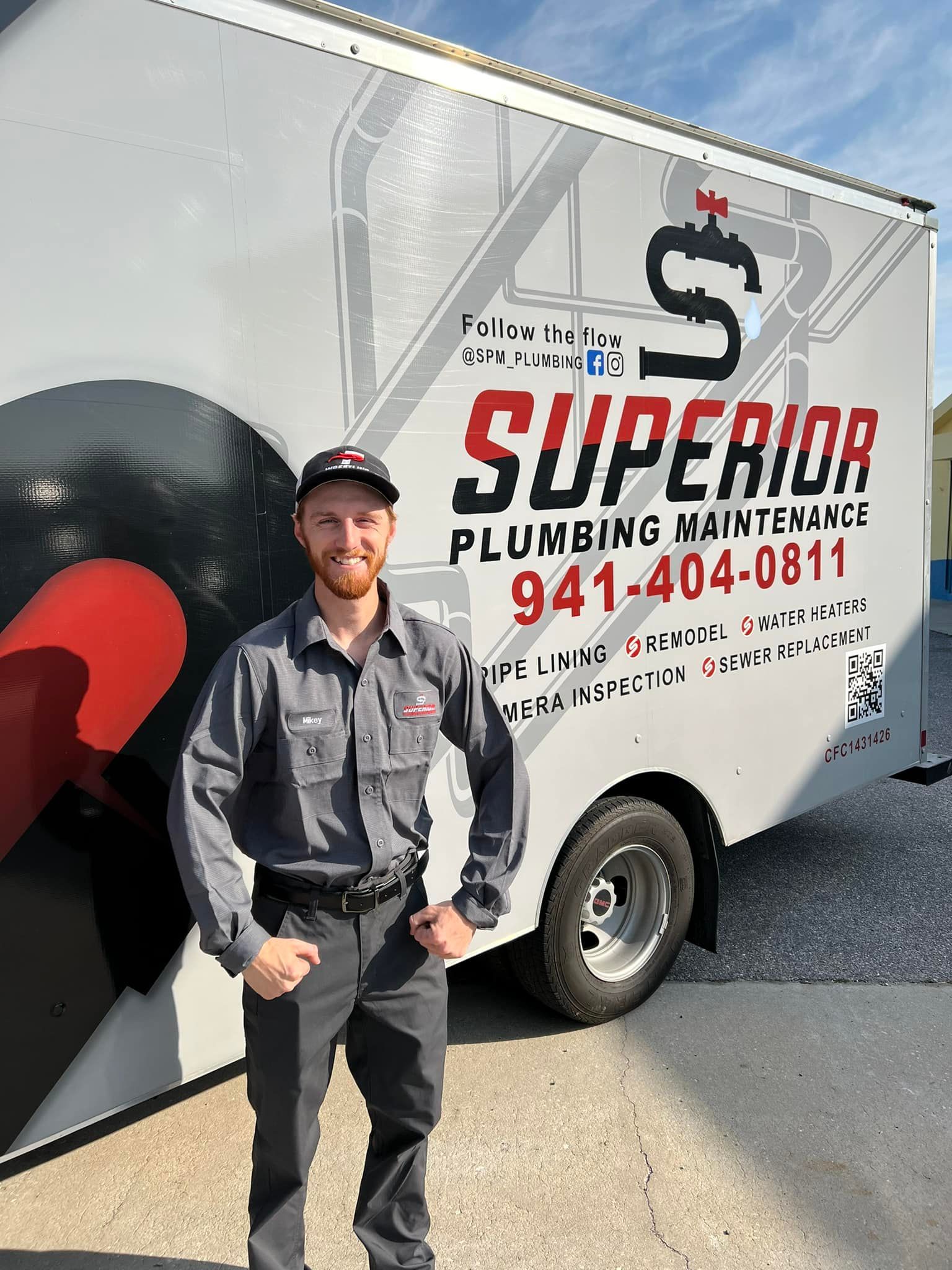Man in uniform stands next to a truck with 