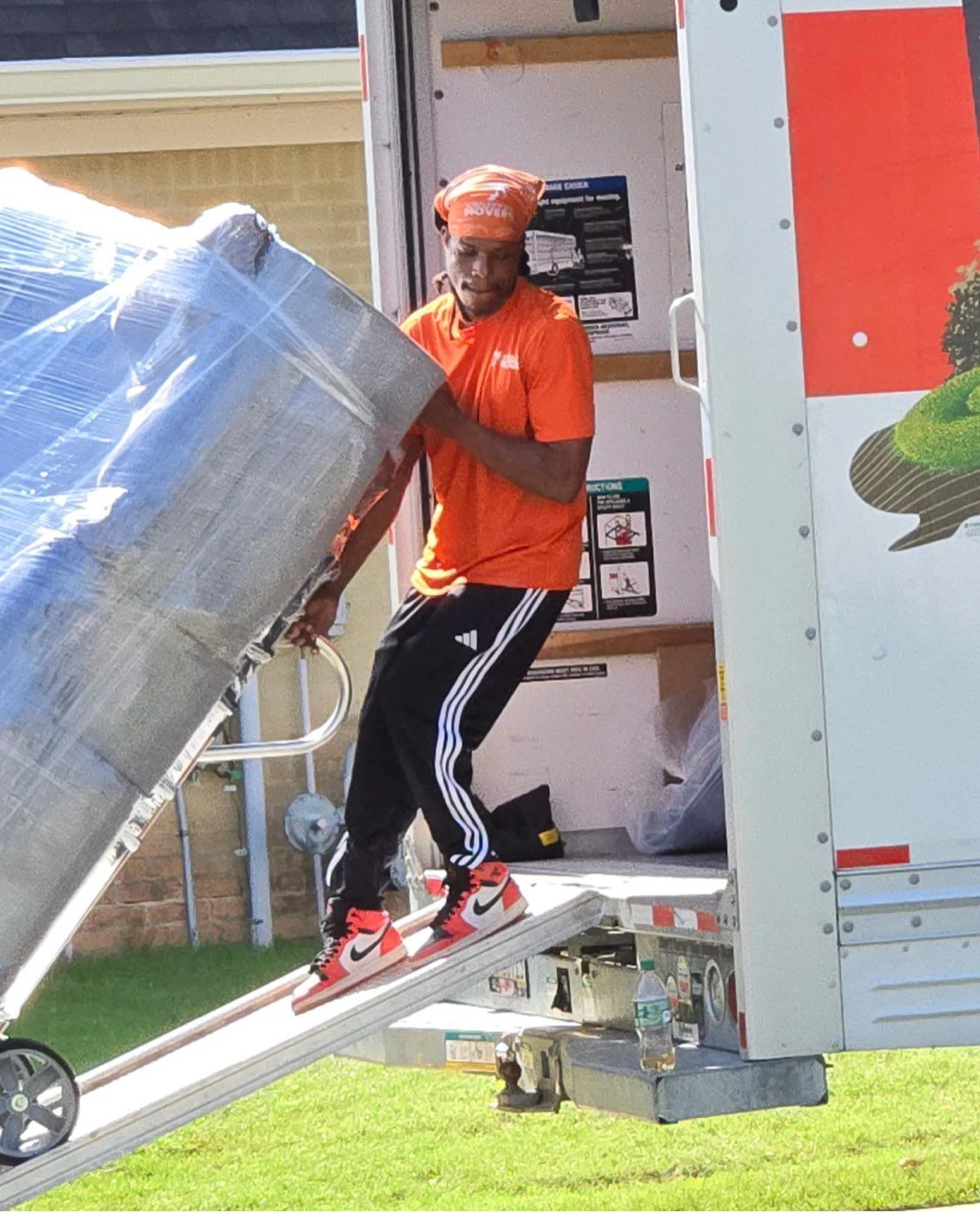Man in an orange shirt on a loading ramp