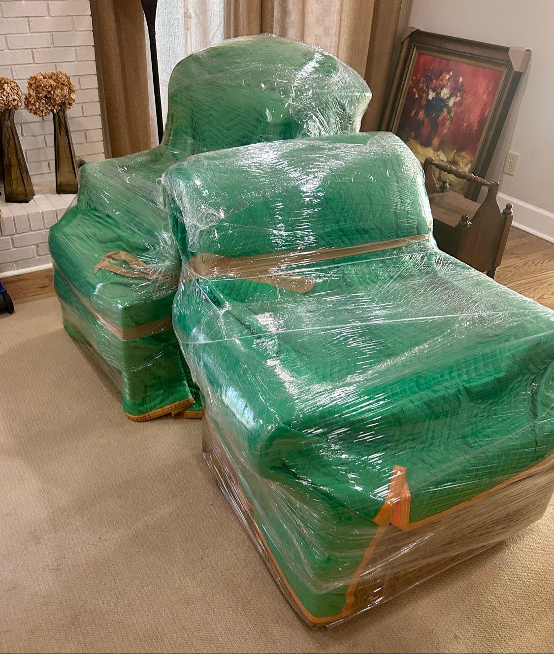 Two armchairs wrapped in plastic