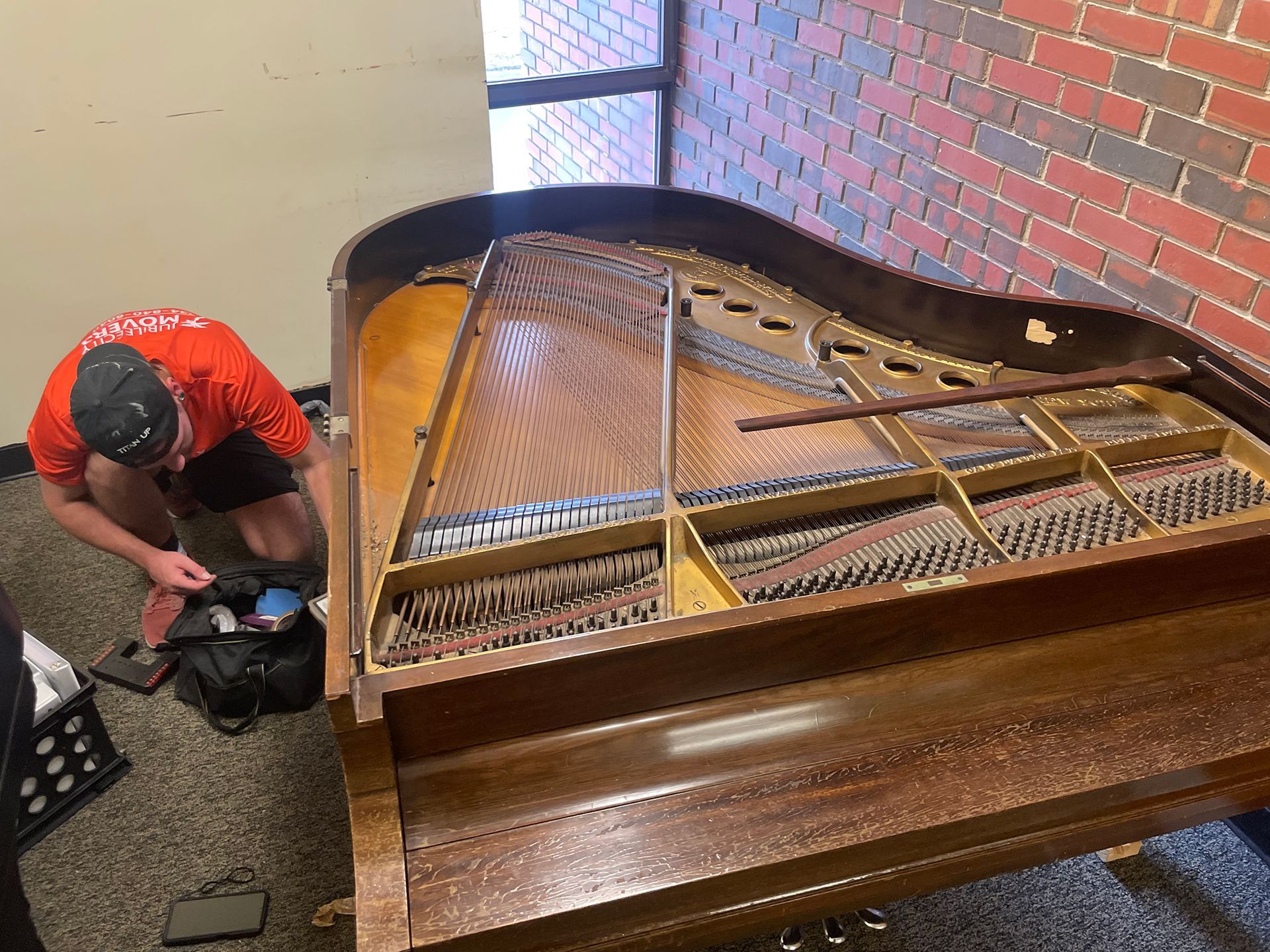 Man dismantling a grand piano