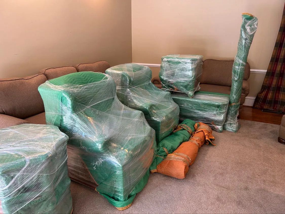 Wrapped green furniture arranged in a living room