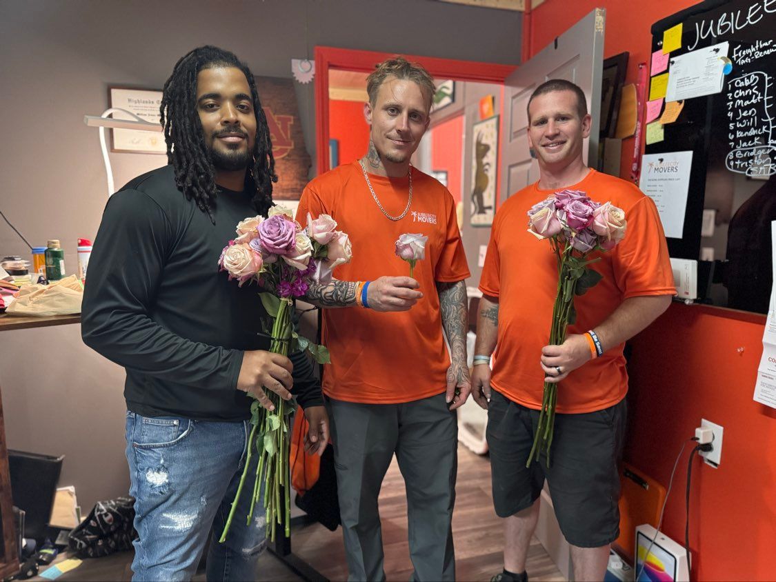 Jubilee City Movers staff holding flowers