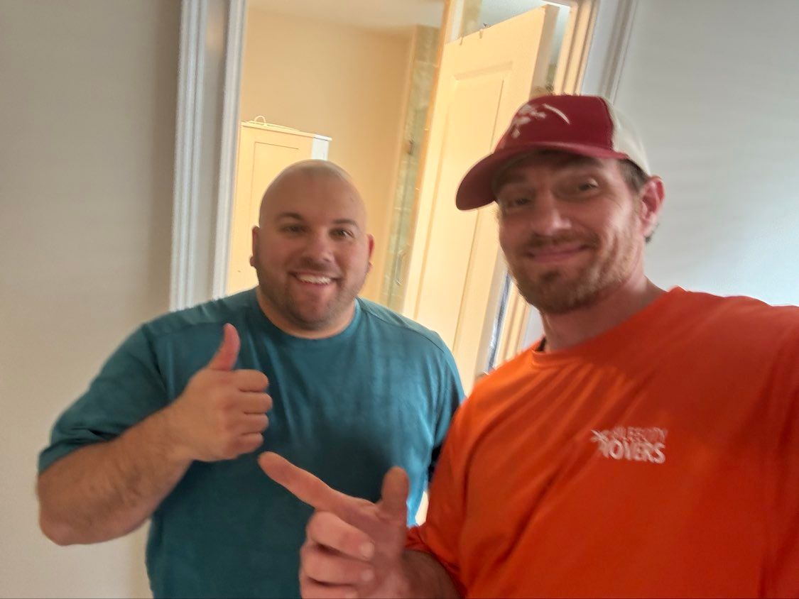 Two smiling men posing indoors