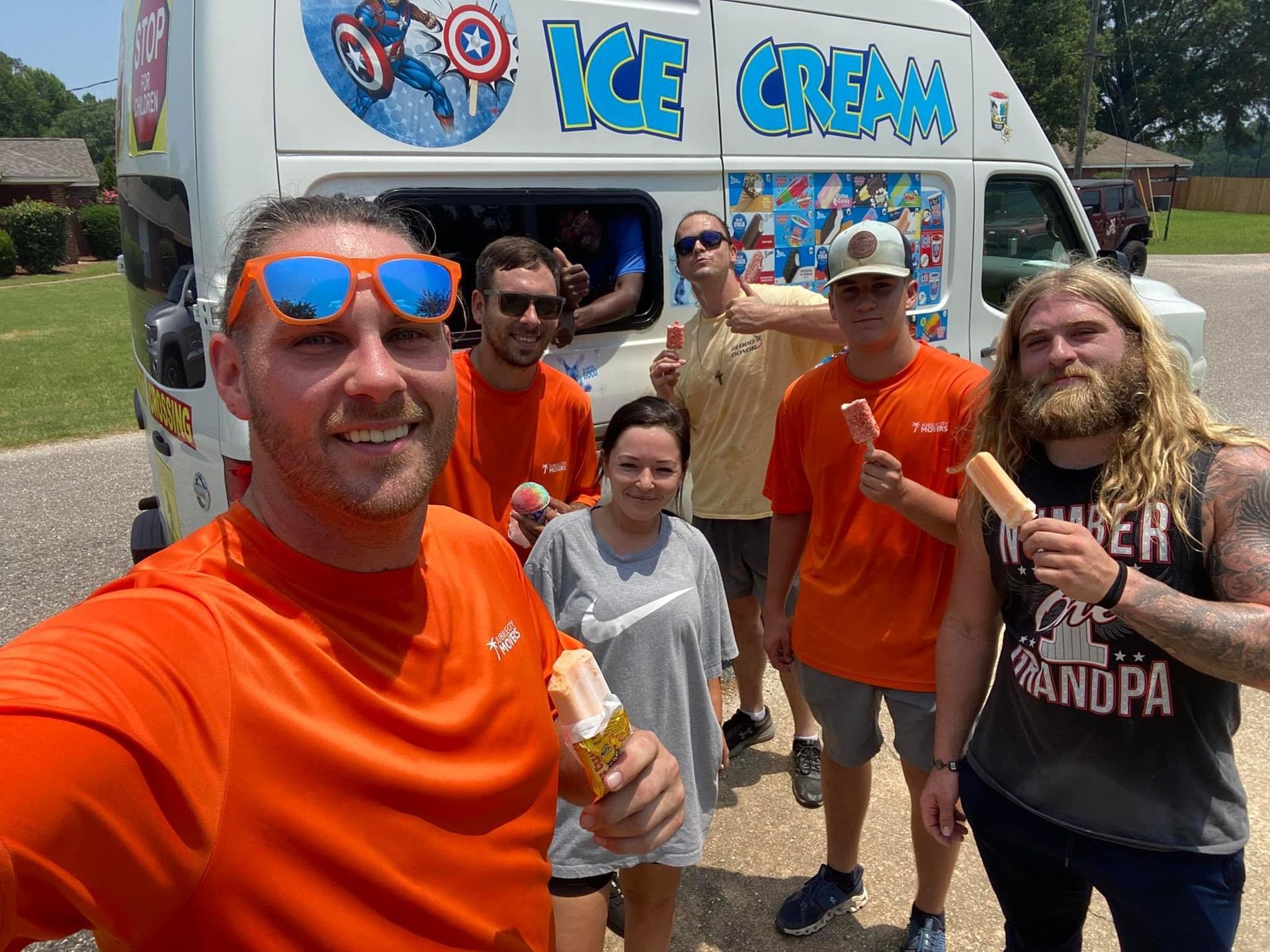 Jubilee City Movers staff posing in front of an ice cream truck