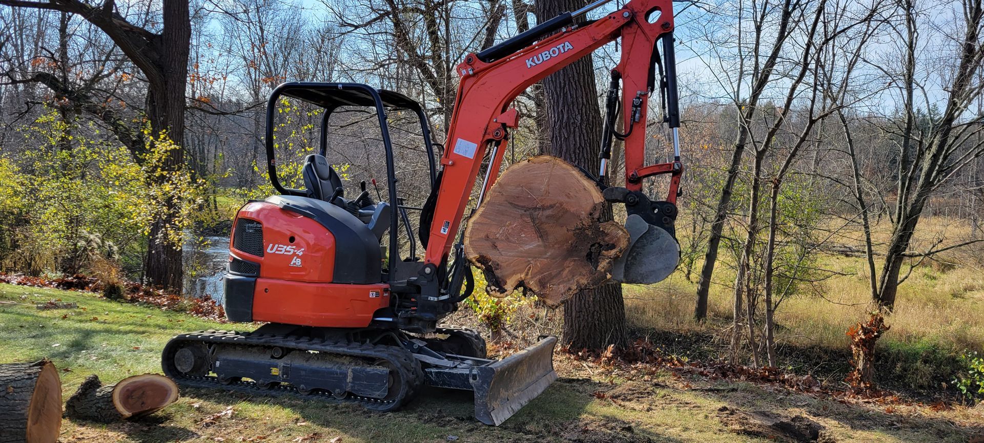 A small excavator is digging a hole in the ground.