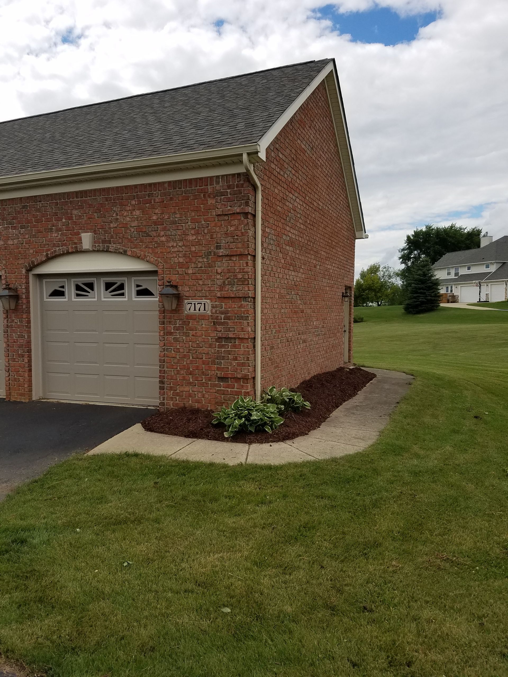 Brick garage with finished flower bed