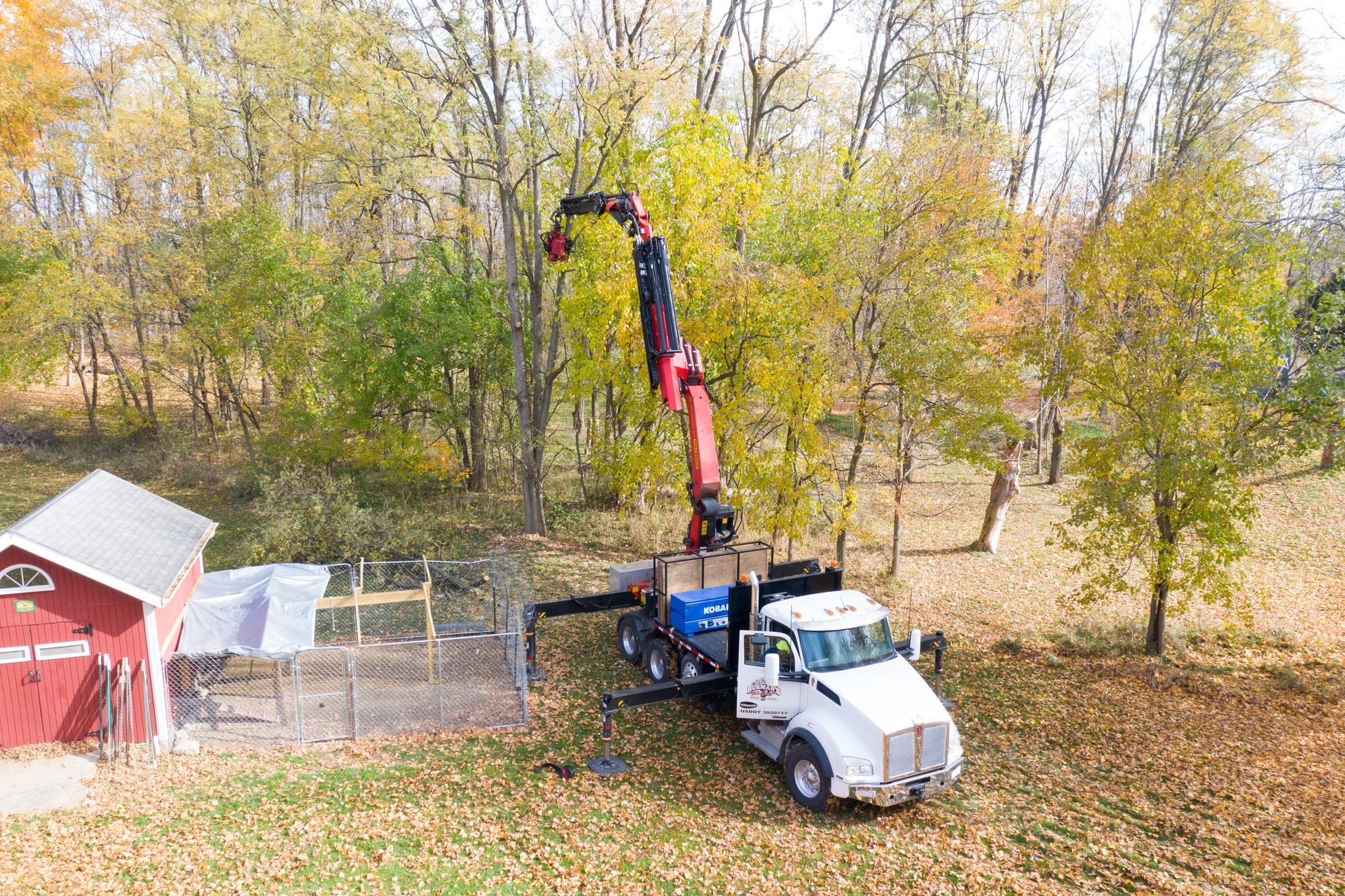An aerial view of a truck with a crane attached to it.