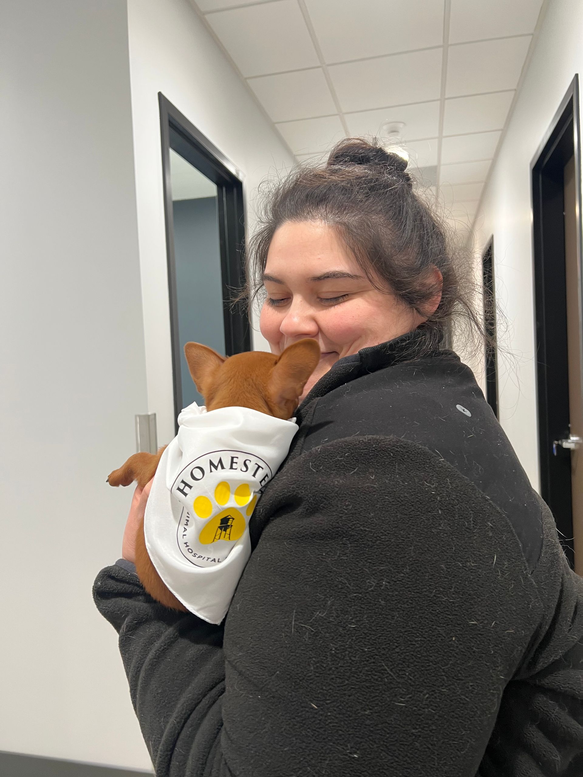 Woman hugging a small dog