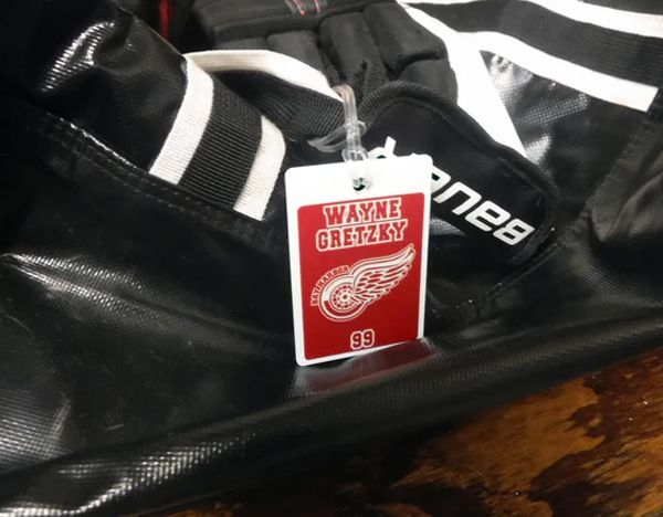 A black bag with a tag that says wayne gretzky on it