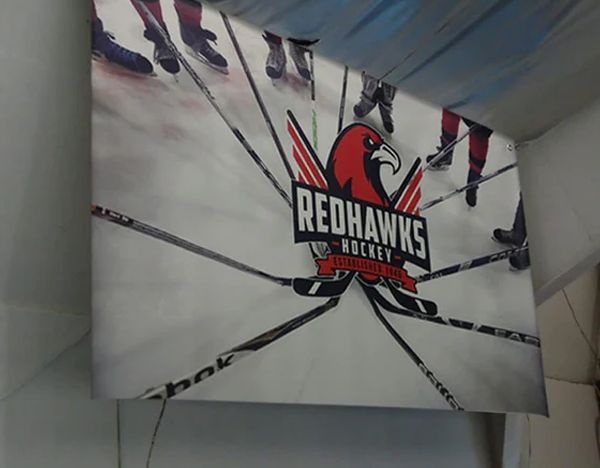 A banner for the redhawks hockey team hangs from the ceiling