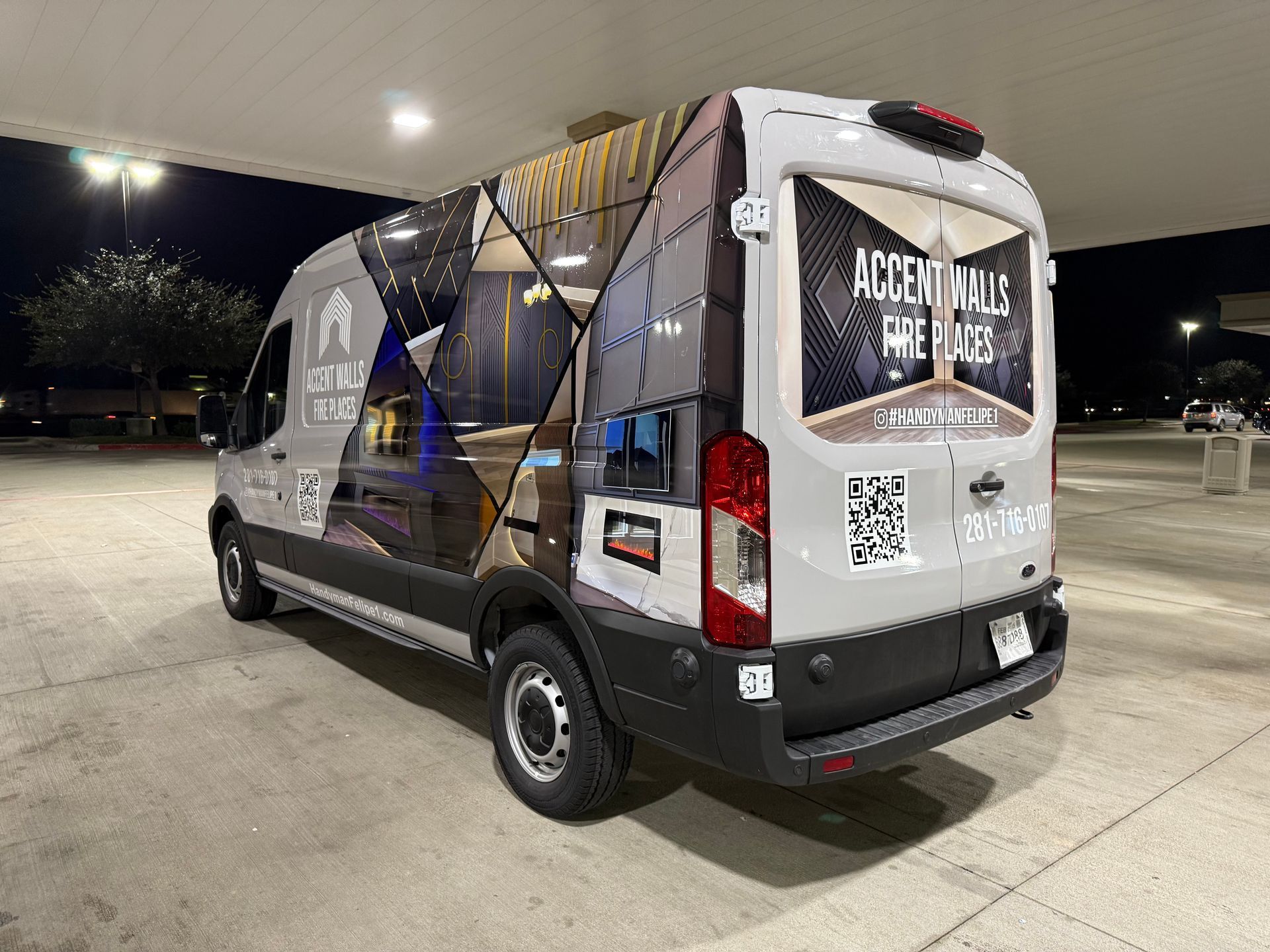 Gray Accent Walls & More van with custom graphics parked at night.