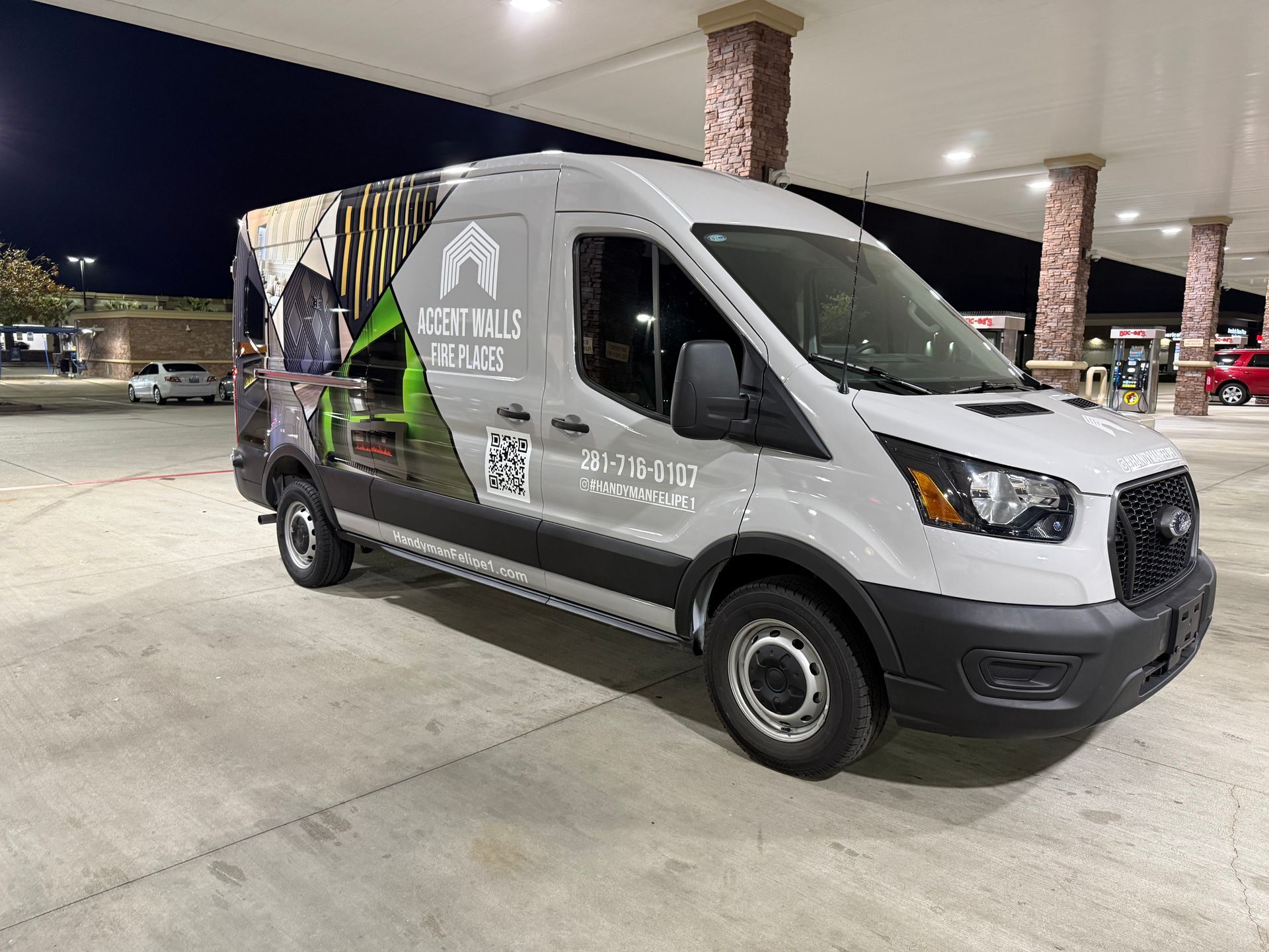 White van with company logo parked at gas station, advertising for 