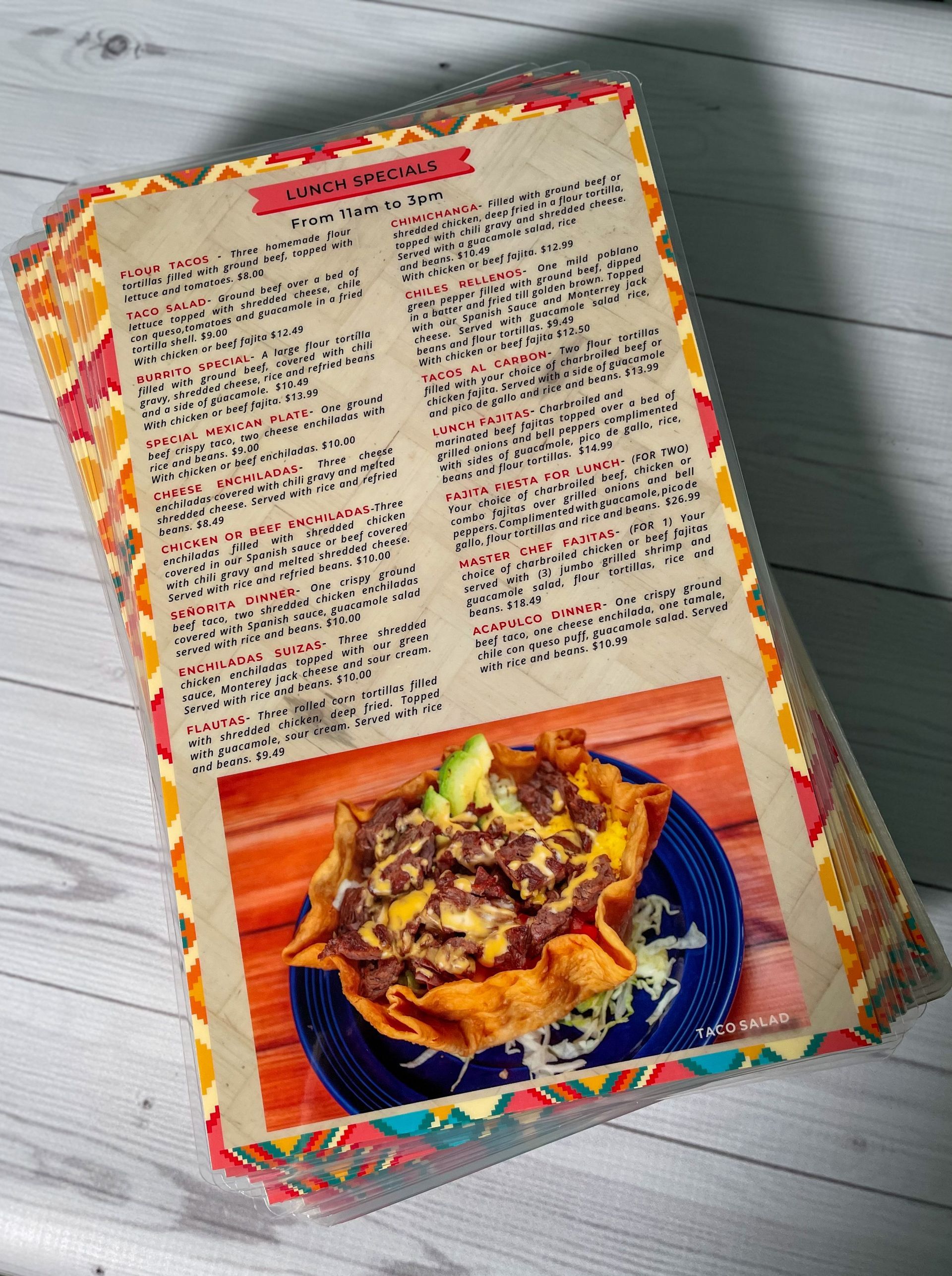 Menu on a colorful placemat, featuring a food photo and text in a Mexican restaurant setting.