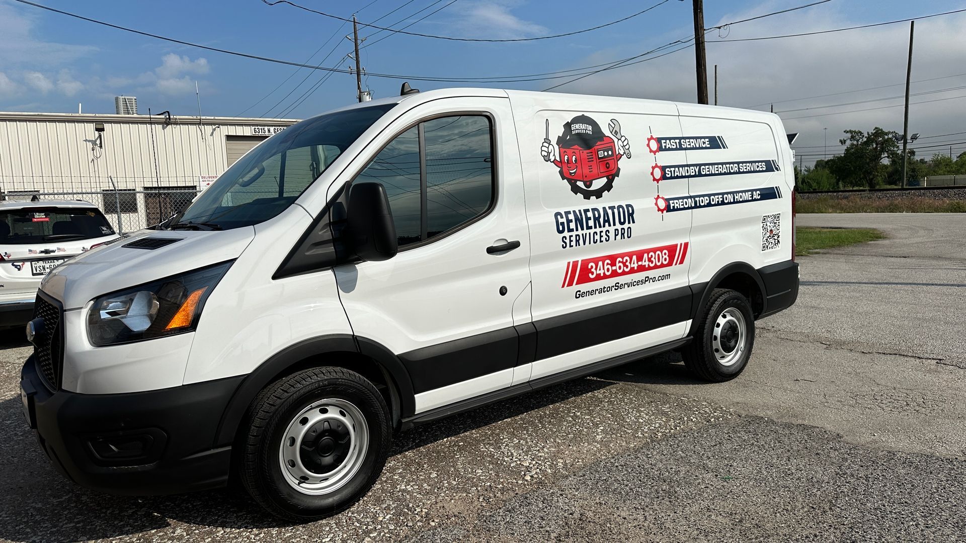 White service van with company logo parked outdoors.