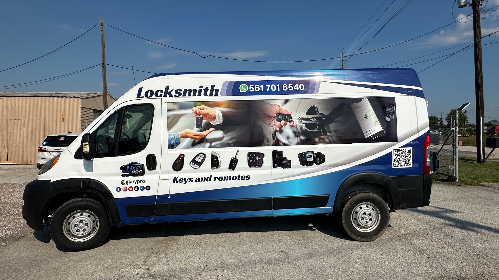 Locksmith van with blue and white wrap, parked outdoors. Includes images of keys and locks.
